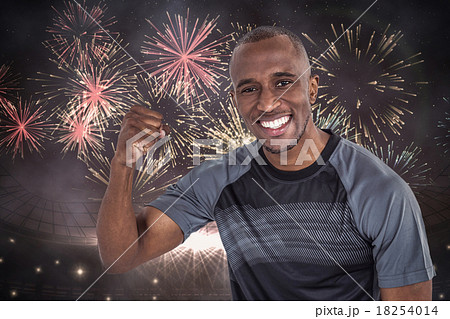 Composite image of portrait of sportsman cheering after success 18254014