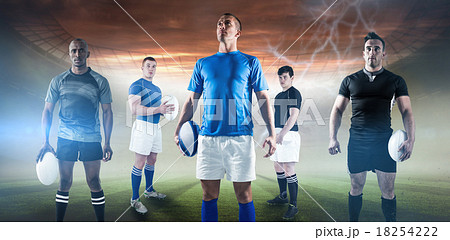 Composite image of portrait of sportsman holding rugby ball while standing 18254222