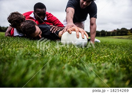 Rugby players tackling during game 18254269