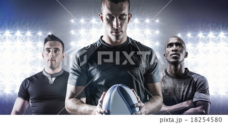 Composite image of thoughtful rugby player holding ball 18254580
