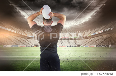 Composite image of tough rugby player throwing ball Composite image of tough rugby player throwing ball 18254648