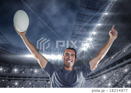 Composite image of portrait of rugby player in blue jersey holdi 18254977