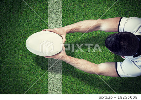 Composite image of high angle view of man holding rugby ball wit Composite image of high angle view of man holding rugby ball wit 18255008