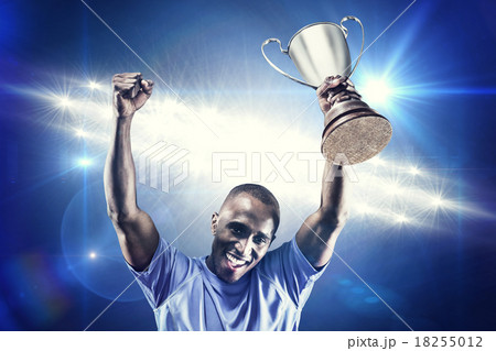 Composite image of portrait of happy sportsman cheering while ho 18255012