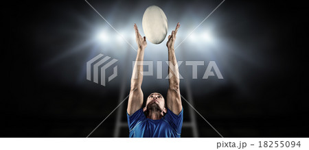 Composite image of rugby player catching ball Composite image of rugby player catching ball 18255094