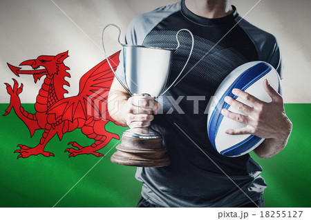Composite image of midsection of successful rugby player holding 18255127
