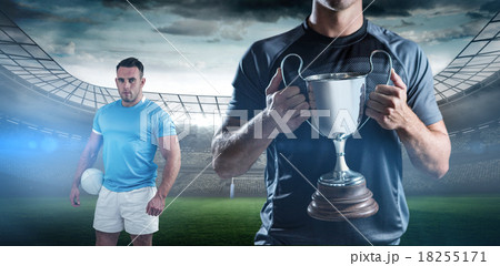 Composite image of victorious rugby player holding trophy Composite image of victorious rugby player holding trophy 18255171