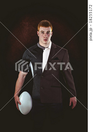 Composite image of rugby player holding a rugby ball Composite image of rugby player holding a rugby ball 18255172