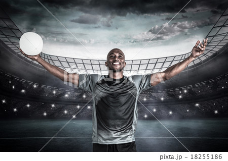 Composite image of confident athlete with arms raised holding ru Composite image of confident athlete with arms raised holding ru 18255186