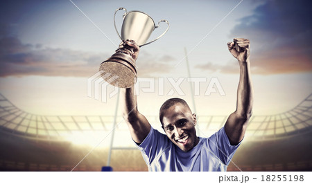 Composite image of portrait of happy sportsman cheering while ho 18255198