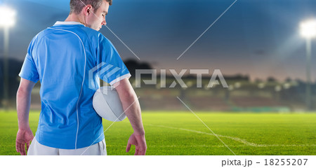 Composite image of rugby player holding a rugby ball 18255207