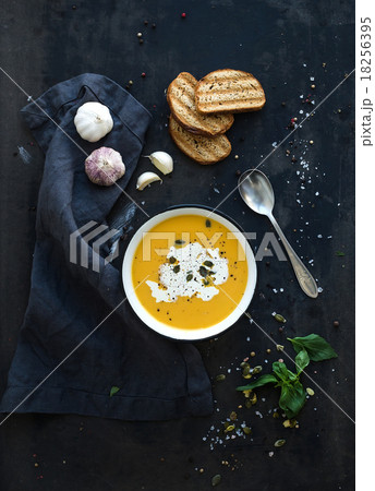 Pumpkin soup with cream, seeds, bread and fresh 18256395
