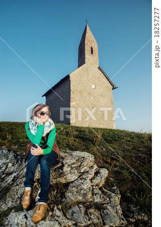 Beautiful caucasian woman is sitting in front of the church Beautiful caucasian woman is sitting in front of the church 18257277