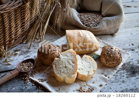 fresh bread and wheat on the wooden table fresh bread and wheat on the wooden table 18260112
