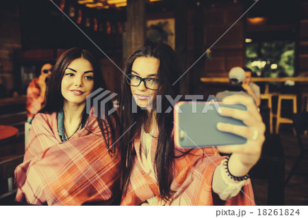 two close friends do selfie in the cafe two close friends do selfie in the cafe 18261824