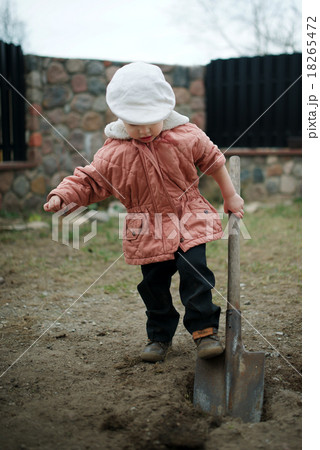 little boy digging a hole 18265472