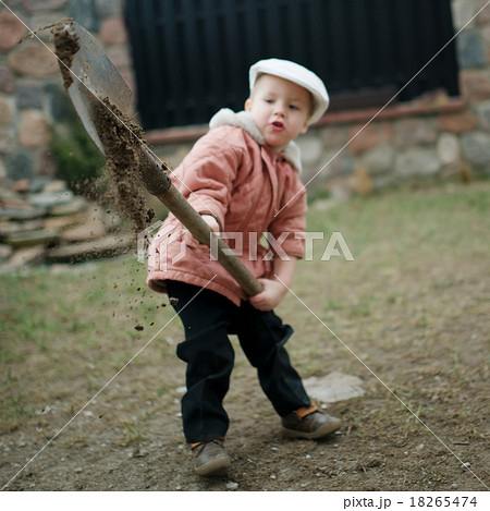 little boy digging a hole 18265474