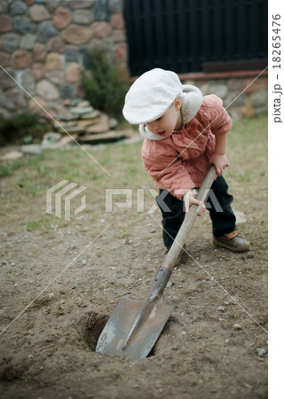 little boy digging a hole little boy digging a hole 18265476