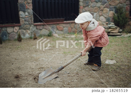 little boy digging a hole little boy digging a hole 18265519