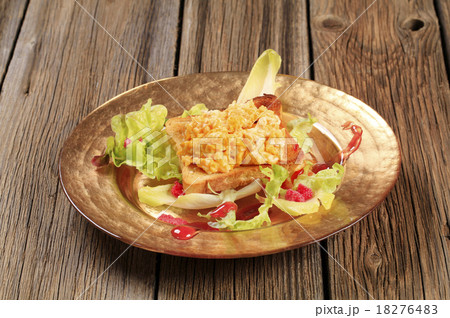 Scrambled eggs on toast and fresh salad 18276483