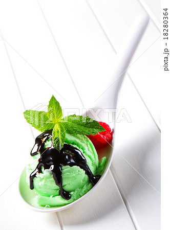 Green ice cream with chocolate syrup 18280364