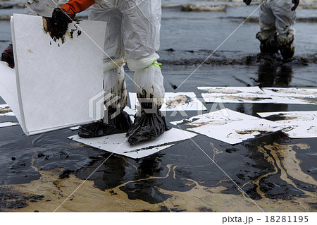 Workers remove crude oil from a beach Workers remove crude oil from a beach 18281195