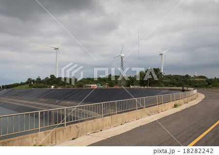 wind turbine generating electricity on reservoir 18282242