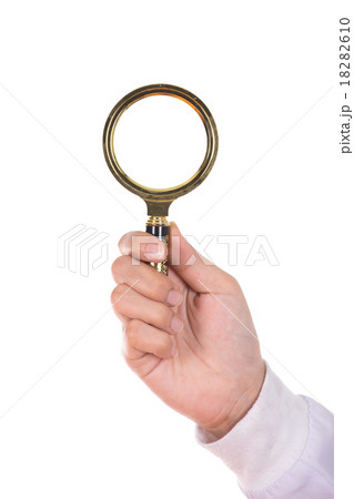 hand holding a Brass Magnifying Glas hand holding a Brass Magnifying Glas 18282610