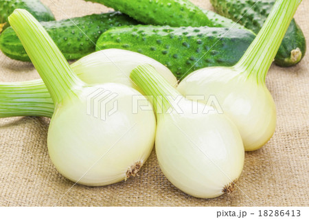 Fresh organic onions with cucumbers on the back Fresh organic onions with cucumbers on the back 18286413