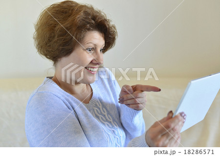 woman in amazement looking at tablet computer woman in amazement looking at tablet computer 18286571