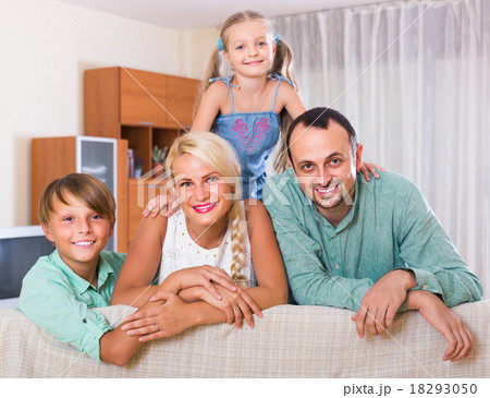 parents with two children posing in home interior parents with two children posing in home interior 18293050