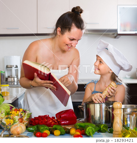 Little girl and mom with cookery book. Little girl and mom with cookery book. 18293421