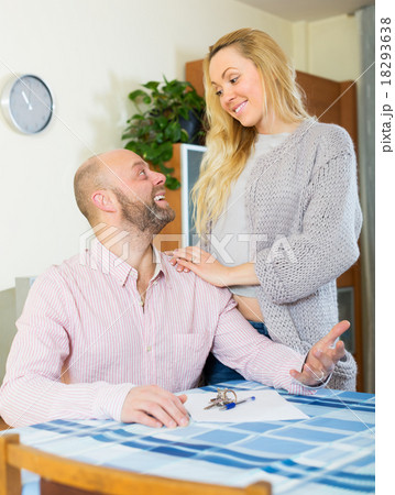 Couple with keys and documents Couple with keys and documents 18293638