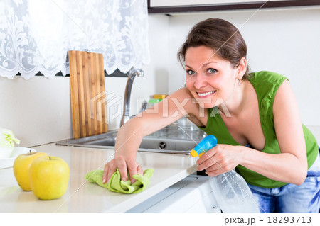 Woman cleaning dust and grease in kitchen 18293713