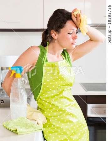 Unhappy woman cleaning furniture Unhappy woman cleaning furniture 18293736