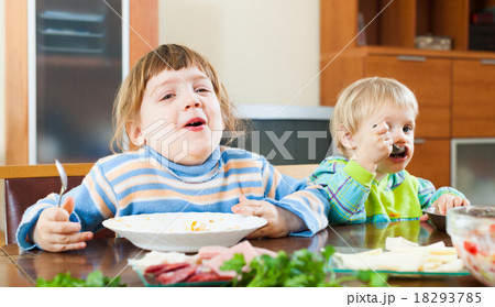 happy girls eating food from plates 18293785
