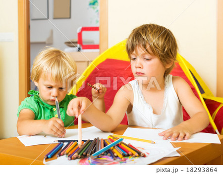 Siblings playing with pencils 18293864