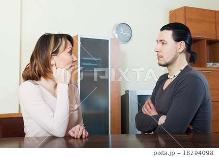 Serious couple talking at home 18294098