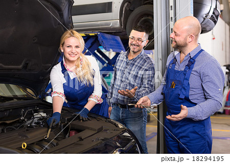Woman mechanic repairing a car Woman mechanic repairing a car 18294195