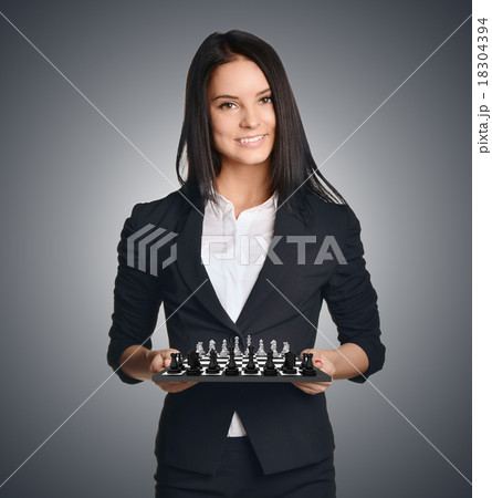 Business woman holding a chess urging to make the 18304394