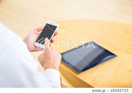 男性　ビジネスマン　携帯電話　手元　携帯電話で検索　情報収集　白背景　インターネット　FX　ゲーム 18305725