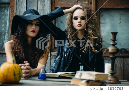 Two vintage witch sitting at the table 18307054