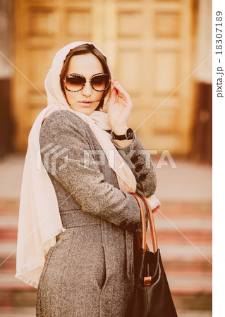 girl in a coat posing on building background girl in a coat posing on building background 18307189