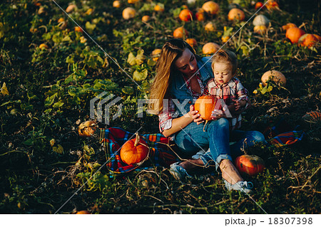 mother and daughter on a field with pumpkins mother and daughter on a field with pumpkins 18307398