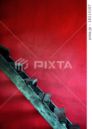 Vintage rusty wooden stair with red cement wall 18314107
