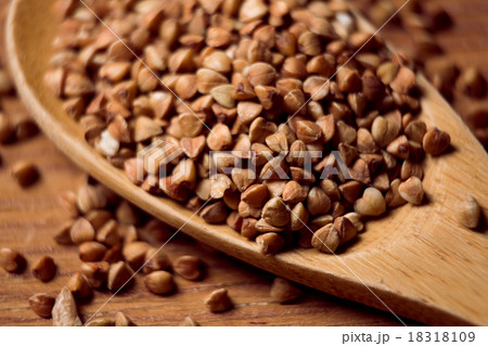 buckwheat groats and wooden spoon 18318109