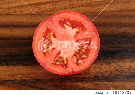 Top view of half tomato on wooden background 18318705