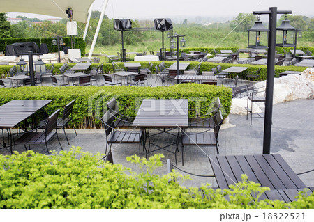 Outdoor restaurant open air chairs with table. 18322521