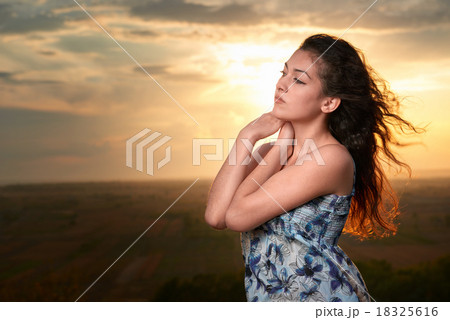 girl portrait at sunset on plain background 18325616