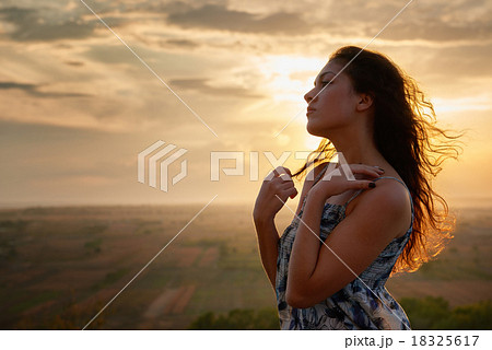 girl portrait at sunset on plain background 18325617